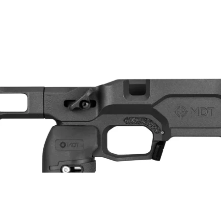 A close up view of the MDT ACC Elite chassis showing the action inlet, grip tape above the trigger, and thumb shelf.