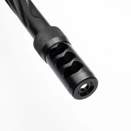 A black Hellfire muzzle brake on a barrel pointing downwards