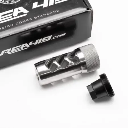 A Hellfire muzzle brake with universal adapter and packaging in stainless steel